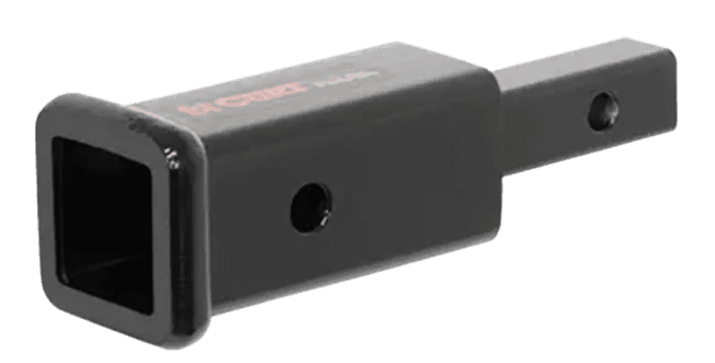 A black plastic device with a red dot on it.