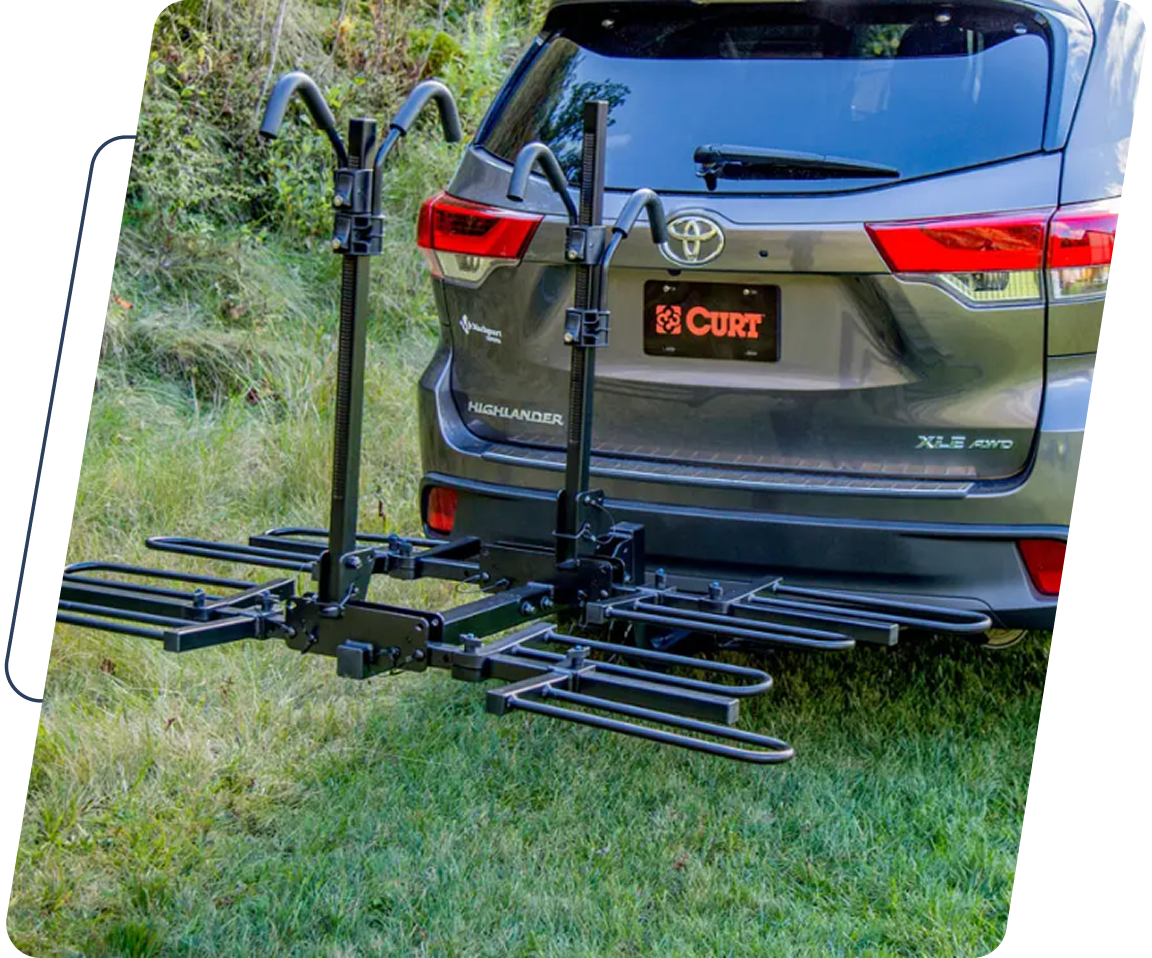 A car with two bikes attached to it's back.